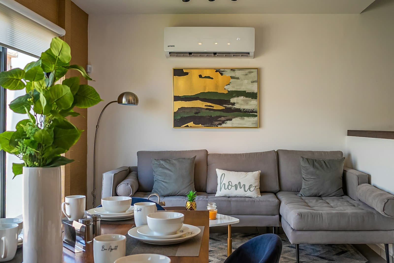Wall-mounted ductless mini split unit cooling a living room